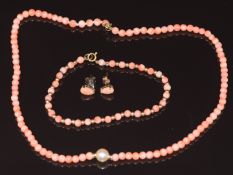 A necklace of coral beads with central pearl and 9ct gold clasp, beaded bracelet of 9ct gold and