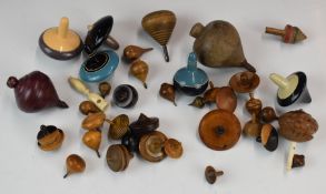 A large collection of 19thC and later treen spinning tops, various specimen woods including