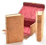 A 19thC pair of cork bound Book of Common Prayer and Hymns, housed in a silk lined cork container