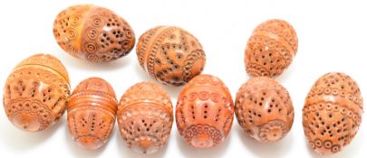 Nine carved coquilla nut thimble / thread holders, tallest 6.5cm