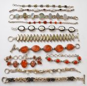 Eleven silver bracelets including coral, shell and agate