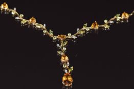 An 18k gold necklace set with citrines, peridot and diamonds in a foliate design, 13.8g