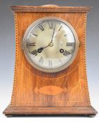 Arts & Crafts or Art Nouveau oak and inlaid mantel clock, with domed top and silvered dial, the