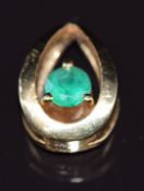 An 18k gold pendant set with an emerald of approximately 0.25ct, 2.7g
