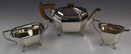 George VI Art Deco hallmarked silver three piece tea set of octagonal form, raised on four feet,