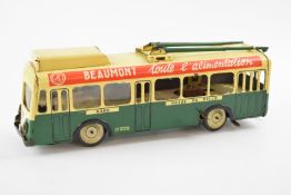 Joustra clockwork tin plate tram, with green/cream body and red/white advertising strip, length