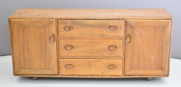 Ercol mid century modern / retro light elm sideboard with an arrangement of two cupboards either