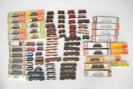 Seventy-eight Hornby Minitrix, Fleischmann and LIma N gauge model railway wagons, most in boxes.
