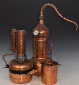 Two copper stills, one with swan neck, hammered style finish and temperature gauge, height of taller