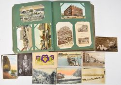 Approximately three forty postcards contained in an Edwardian postcard album and loose including