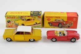 Two Dinky Toys diecast model vehicles Triumph Spitfire with red body, cream interior and driver