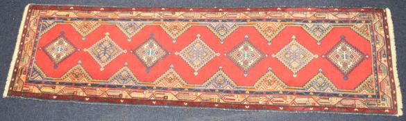 Turkoman runner with seven guls on a wine ground, 285 x 80cm