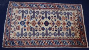 Turkoman rug with geometric design and borders on a cream ground, 177 x 110cm