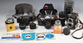 Two Praktica 35mm SLR cameras comprising Super TL 1000 and super TL, together with Cosinon 55mm 1: