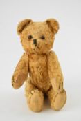 Vintage Teddy bear with golden mohair, brown glass eyes, jointed limbs, shaved snout and black
