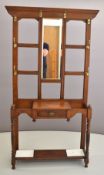 Edwardian oak hallstand with brass hooks and bevelled edge mirror to back, height 196cm