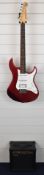 Yamaha Pacifica electric guitar finished in red, with Yamaha GA-15 guitar amp and guitar case.