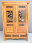 Chinese mixed wood housekeeper's cupboard with fitted interior and figural carved panels and drawers