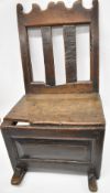 Antique oak rocking chair with pegged joints and compartment below