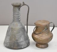Eastern pedestal copper jug with cover and a large hammered pitcher, tallest 49cm