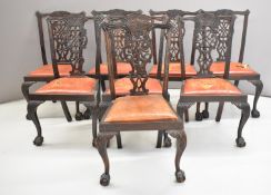 A set of eight Victorian mahogany Chippendale style chairs with drop in upholstered seats, raised on