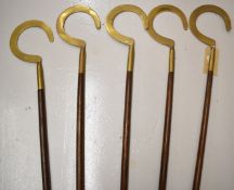 Set of five likely religious staffs, each with brass crescent finials, height 189cm