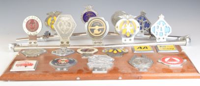 Twenty various classic car badges, some on bars, including Butlins car club, AA, Caravan Club,