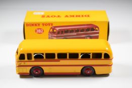 Dinky Toys diecast model Duple Roadmaster Coach with yellow/red body, silver grille and red hubs,