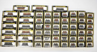 Fifty-seven Graham Farish GWR, LNER, LMS and SR N gauge model railway wagons including brake vans,