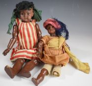 Two 19th/20thC dolls with porcelain heads, pierced ears and articulated limbs, numbered to the