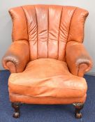Chesterfield style brown leather armchair with mahogany ball and claw feet