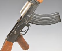 Deactivated AK47 7.62x54mm assault carbine rifle with wooden pistol grip, adjustable sights, belt