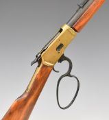 Winchester style lever action replica rifle with wooden stock and brass coloured action, 95cm long.