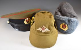 Three Russian military hats comprising a peaked cap, cold weather example, and a khaki cap, WW1