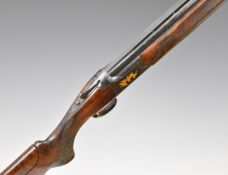Browning Citori 12 bore over and under shotgun with gold engraving of birds and dogs surrounded by