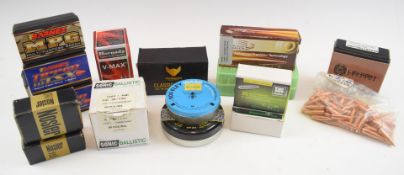 A collection of .30 and .308 rifle bullets and two tins of air rifle pellets.