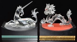 Two Swarovski Crystal glass animals dragon and uniform, both on display plinths, each base 15cm