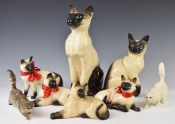 A collection of Beswick / Royal Doulton cat figures including fireside example, tallest 35cm