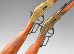 A pair of Winchester style lever action replica rifles, each with huntsmen, deer and dogs embossed