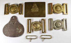 Four belt buckles including Royal Marines, Coldstream Guards and Dieu Et Mon Droit and a foot locker