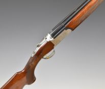 Browning Medalist 12 bore over and under ejector shotgun with named and ornately engraved lock,
