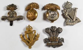 Six British Army Irish regiment cap badges including Leinster Regiment, Connaught Rangers, Royal