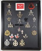 Mounted display of approximately 25 British Army badges, mostly anodised, including 6th Gurkha
