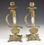 A pair of brass candle sticks in the form of sword handles, height 27cm