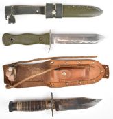 Two fighting knives, one with wooden handle and serrated 13cm Bowie type blade, the other stamped