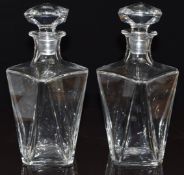 A pair of Baccarat clear faceted glass decanters and stoppers, 23cm tall.