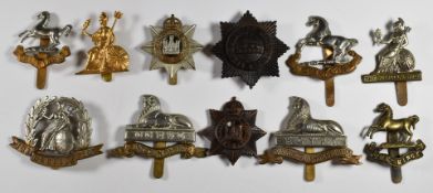 Eleven British Army metal cap badges including Officer's Service Dress, Lincolnshire Regiment,