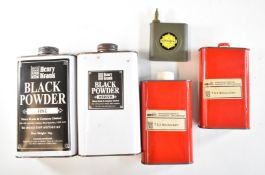 Four black powder gunpowder tins and a Valvespout oil bottle, largest canister 20cm tall.