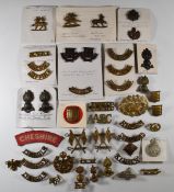Approximately forty metal shoulder and collar badges including Royal Engineers, the Buffs, Essex