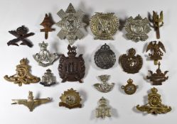 Twenty British Army cap badges including Highland Light Infantry, Jewish Brigade, Queen's Own